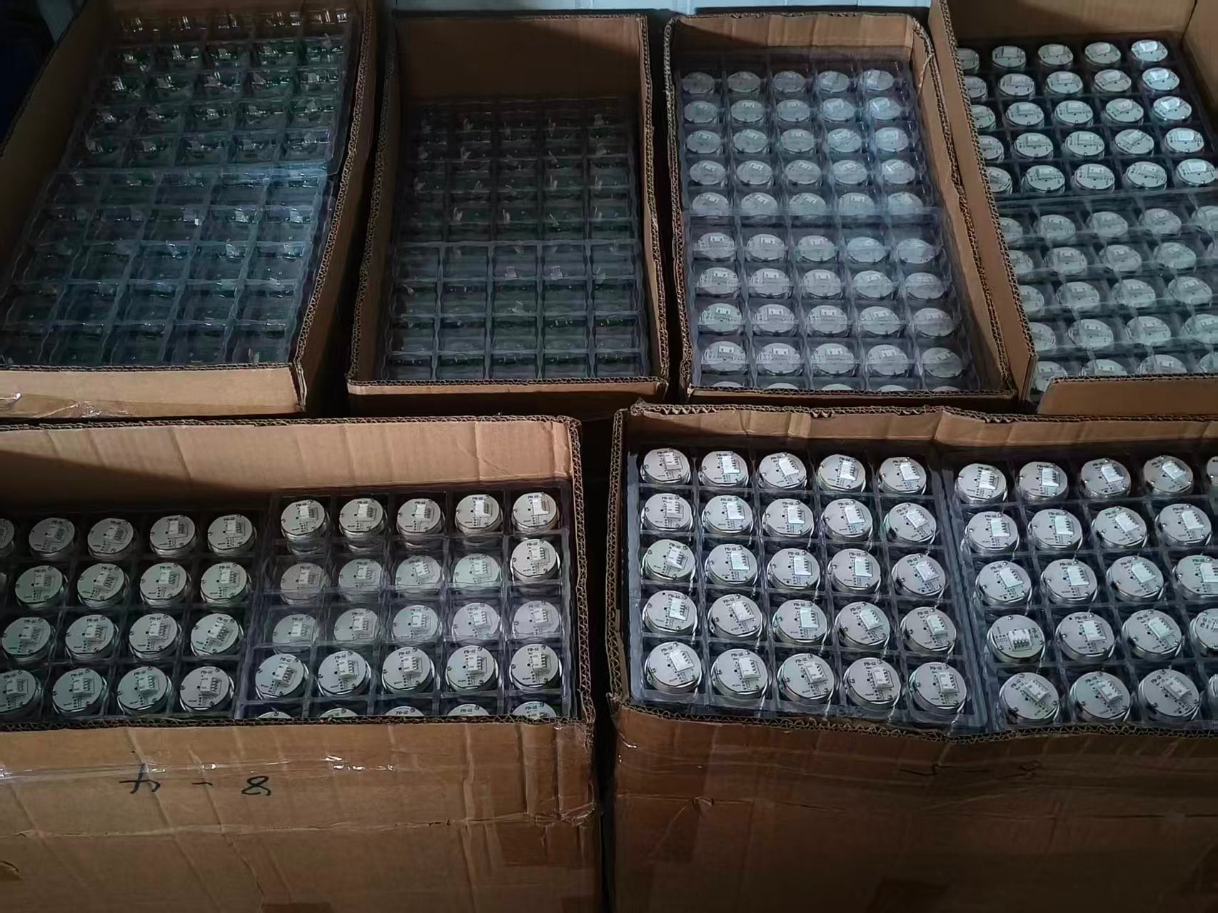 Elevator button rear assemblies arranged in production batches