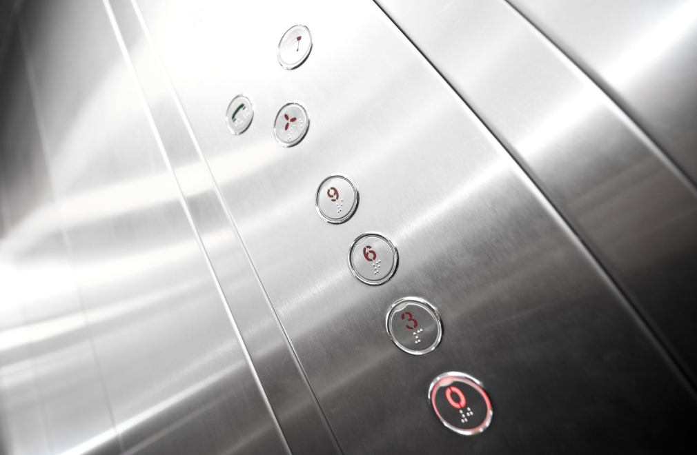 Round elevator buttons installed in a brushed metal operating panel